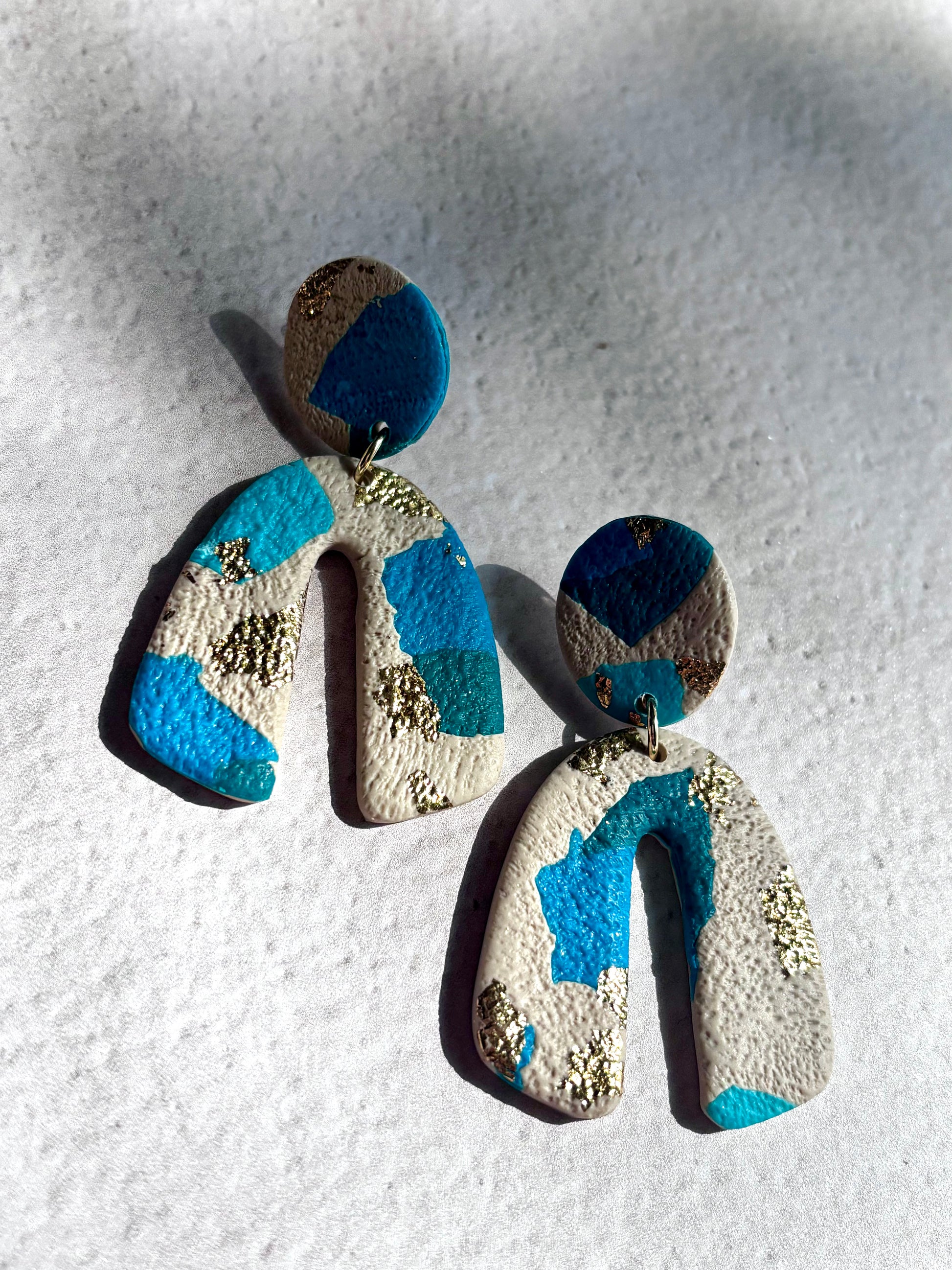 Boucles d’oreilles bleues et dorées légères de la marque Les Trésors de Cia, en métal fin et élégantes.